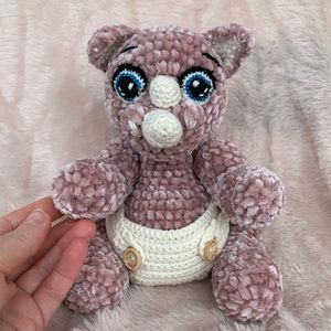 Handmade crocheted plush cute baby rhino in diapers.